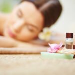 Products for beauty care with relaxed female on background